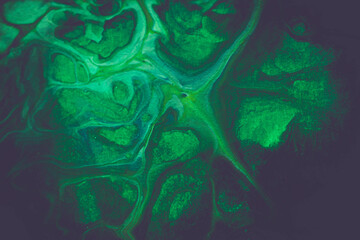 Abstract background from spilled paints. Multi-colored paints on canvas.