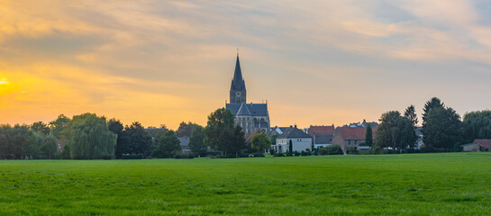 Obraz premium Panorama of dutch town of Thorn in Province Limburg by the sunset with dominant tower of St. Michael Abbey Church