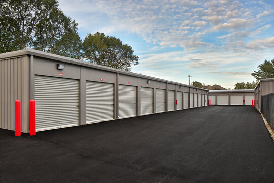 Modern warehouse garage storage facility under cloudy sky