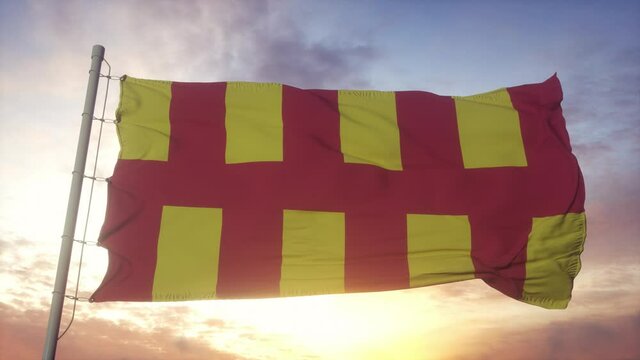 Northumberland flag, England, waving in the wind, sky and sun background