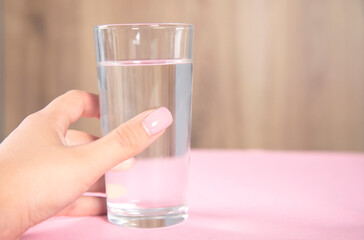 woman holding glass of water