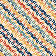 Vector ethnic pattern. Tribal traditional ornament with colored diagonal zigzags and lines. The seamless background is used for the design of carpets, clothing, textiles, wallpapers, business cards.