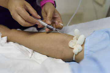Nurse hand taking blood from the vein of a patient