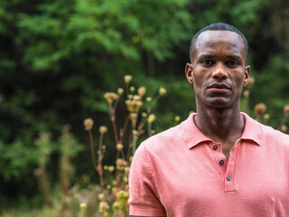 portrait of a young fit african man in a park in early autumn