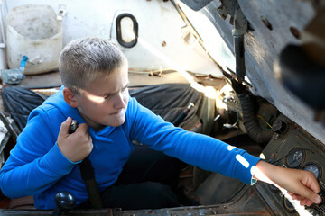 Boy playing in GT-MU light generalpurpose armored vehicle