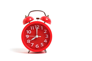 Red alarm clock isolated on a white background shows eight clock in morning.