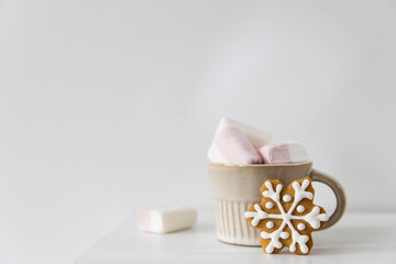 Christmas or New Year composition with cocoa, gingerbread cookies and christmas decorations. Hot chocolate with marshmallows on white background of table. Copy space. Mock up