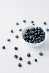 Beautiful ripe blueberries in a glass bowl on a white background. Healthy food, and vitamins.