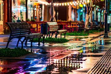 rain night cafe, autumn bench city. light outdoor lamp. street illumination after evening night...