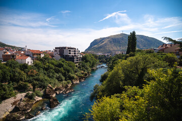 View over Neretva river during a sunny day in Mostar, touristic destination in Bosnia and...