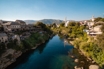 Fototapeta na wymiar Mostar, Bosnia and Herzegovina - September 12 2021: View over Neretva river during a sunny day in Mostar, touristic destination in Bosnia and Herzegovina, Europe
