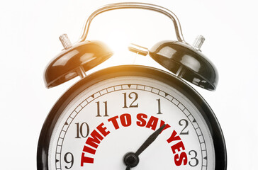 On the dial of the alarm clock the inscription - TIME TO SAY YES