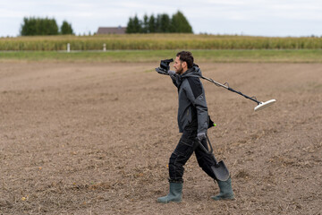 Looking for metal with a metal detector.