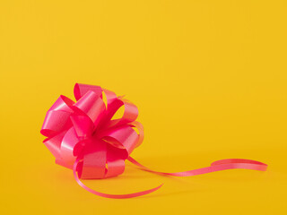 pink bow against illuminating yellow background. helloween. holliday. christmas. with copy space