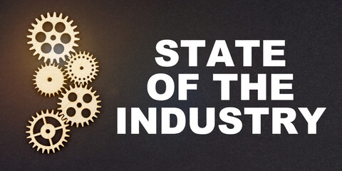 Fototapeta na wymiar On a black background, gears and the inscription - STATE OF THE INDUSTRY