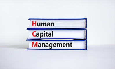 HCM, Human capital management symbol. Concept words HCM, Human capital management on books on a beautiful white background. Business, HCM, Human capital management concept. Copy space.