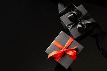 Craft gift boxes with bows on a dark background. Holiday festive template.
