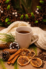 
Beautiful stylish christmas composition with a cup of tea, cinnamon and pine cones
