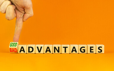 Good or bad advantages symbol. Businessman turns a wooden cube, changes words bad advantages to...