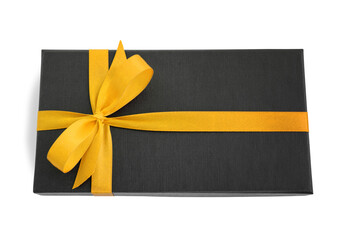 Black gift box (present) with yellow satin ribbon bow, isolated on white background