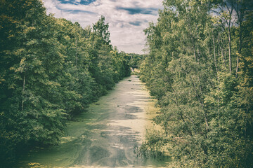 Scenic view of abandoned Mazursky canal, former West Prussia, old photo stylization