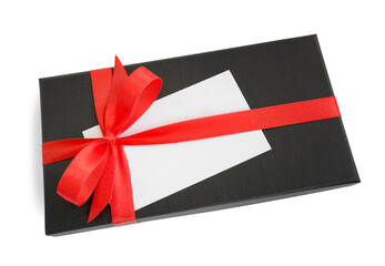 Black gift box (present) with red satin ribbon bow and a blank card with copy space, isolated on white background