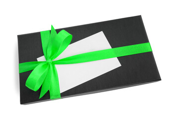 Black gift box (present) with green satin ribbon bow and a blank card with copy space, isolated on white background
