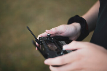 hands controlling drone rc controller