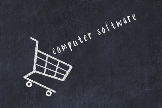 Chalk drawing of shopping cart and word computer software on black chalboard. Concept of globalization and mass consuming