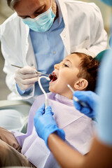 Fototapeta premium Small boy having teeth check-up at dental clinic.