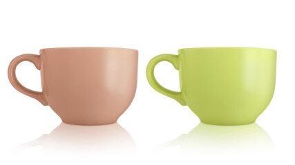 Ceramic cups. Two large empty ceramic mug isolated on white background. Mugs with a handle. Green and brown cups.