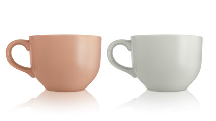 Ceramic cups. Two large empty ceramic mug isolated on white background. Mugs with a handle. Brown and gray cups.