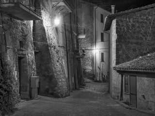 night street with lights and stone houses in italian city Capodimonte in Italy