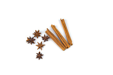 Star anise, cinnamon sticks on a white background, top view, isolated on white. 