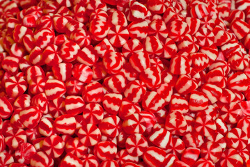 Texture of red and white jelly candies. Sweets on a pile close up. Sweets shop window.