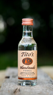 NORWALK, CT, USA - SEPTEMBER 22, 2021: Little bottle with Tito`s Handmade  vodka on table outside
