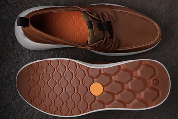 Light brown casual leather men shoes. Men moccasins against stone background