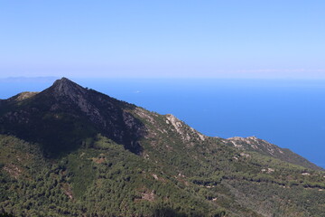 Elba, Italy – September 01, 2021: beautiful places from Elba Island. Aerial  view to the island. Little famous villages near the beaches. Summer tourist places. Clouds and blue sky in the background.