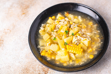 soup vegetable corn, potatoe, pasta alphabet, broth, chicken meat fresh portion meal snack on the table copy space food background rustic keto or paleo diet 