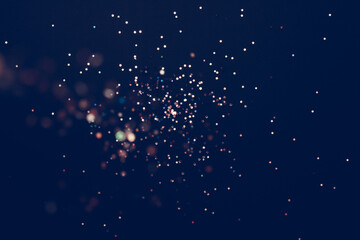 festive background with confetti in the form of stars on a dark blue background.