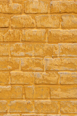 Brick and plaster yellow ochre background.