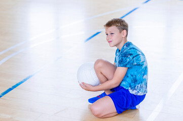 School kid playing volleyball in a physical education lesson. Horizontal education poster, greeting...