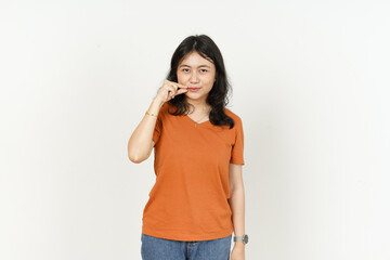 Keep Secret lip shut of beautiful asian woman Wearing orange T-shirt isolated on white background