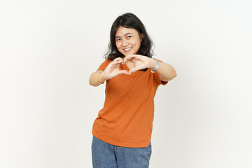 Showing heart shape hand sign of beautiful asian woman Wearing orange T-shirt isolated on white background