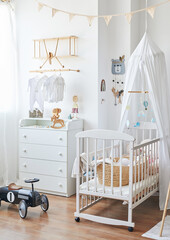 Scandinavian style white interior children's room, bedroom, nursery. Baby cot with ​canopy. Wooden shelves and toys. Wooden shelf in form of an airplane