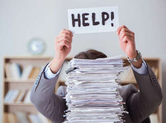 Businessman busy with paperwork in office