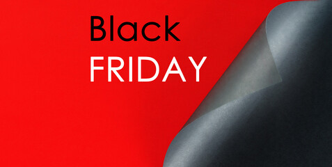 black folded sheet of paper, the inscription black friday on a red background