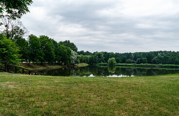 Summer landscape. Beautiful lake in the park. Natural background wallpaper postcard.