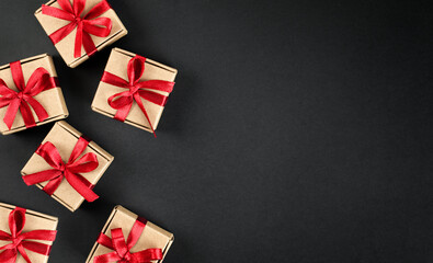 brown gift boxes with red bows on dark background