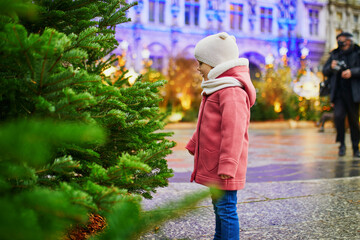 Adorable preschooler girl on Christmas market in Paris, France